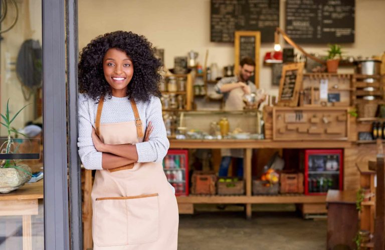 Portrait,Of,A,Smiling,Young,African,American,Barista,Leaning,With